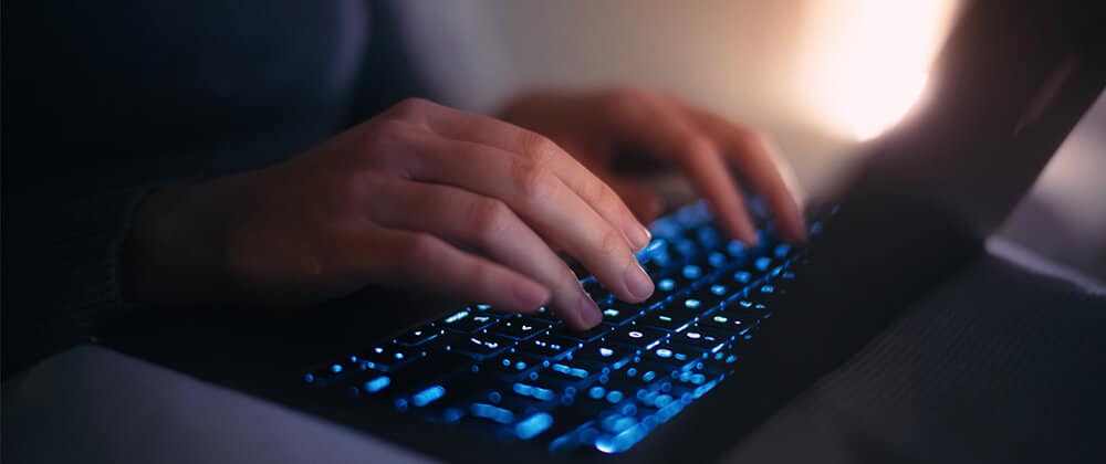 Person typing on a keyboard