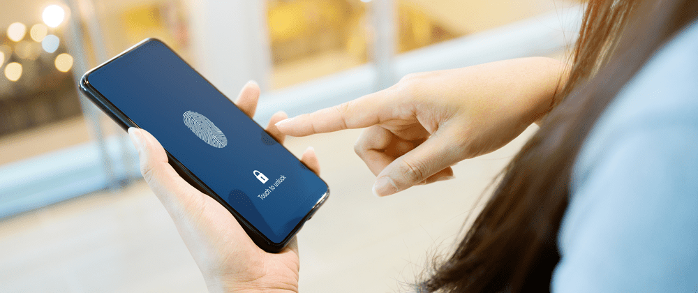 A woman using her fingerprint to unlock her mobile.